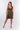 Front view of olive green Jen V-Neck Empire Waist Knit Dress A-line silhouette defined waist resort