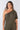 Close-up of silky-soft knit on olive green Gigi Asymmetrical One-Shoulder Knit Jumpsuit smooth texture easy fit