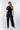 Second view of navy white Lee Asymmetrical One-Shoulder Knit Jumpsuit one-shoulder silhouette coastal