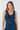 Close-up of silky-soft knit on navy Reese V-Neck Knit Ruffle Dress ruffle detail draped finish