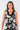 Close-up of silky-soft knit on floral black white Juno Above-Knee U-Neck Knit Dress contrast neckline detail