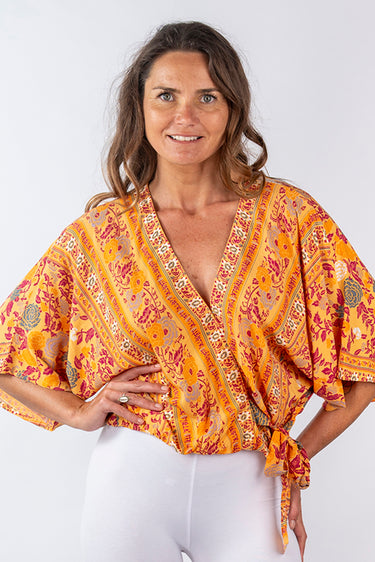 Front view of floral yellow gold Ariel Kimono Sleeve V-Neck Wrap Top kimono silhouette relaxed fit resort