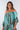 Close-up of super-soft rayon on brown tie-dye blue green Kylie Convertible Off-Shoulder Dress With Ruffle Sleeves finish