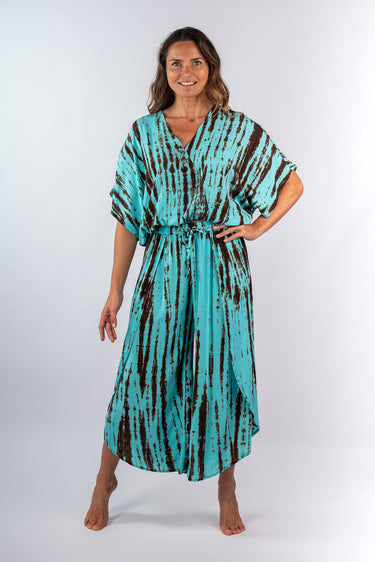 Front view of brown tie-dye blue green Sara Ankle-Length Mock Wrap Pants relaxed wide-leg silhouette resort
