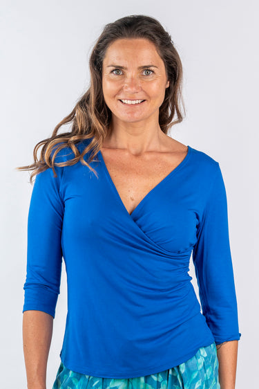 Close-up of silky-soft knit on blue Janice 46115 Sleeve V-Neck Wrap Knit Top wrap detail draped finish