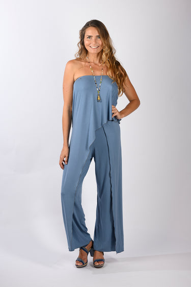 Side view of blue Gigi Asymmetrical One-Shoulder Knit Jumpsuit one-shoulder silhouette fluid drape coastal