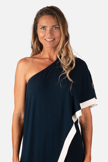 Close-up of silky-soft knit on navy white Lee Asymmetrical One-Shoulder Knit Jumpsuit smooth texture finish