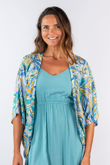 Close-up of super-soft rayon on floral multicolor Sienna 46115 Sleeve Butterfly Wing Shrug print placement varies