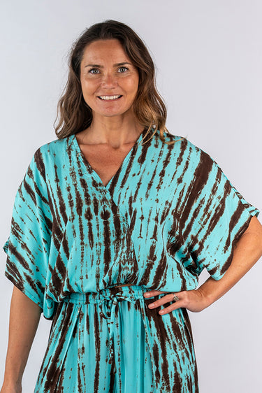 Close-up of super-soft rayon on brown tie-dye blue green Lela V-Neck Dolman Sleeve Top artisanal finish