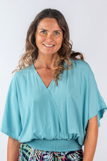 Close-up of super-soft rayon on turquoise Lela V-Neck Dolman Sleeve Top smooth texture dolman finish